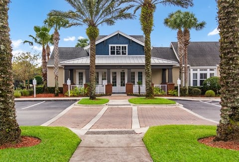 a large house with palm trees in front of it